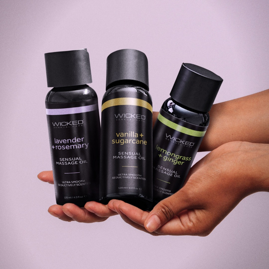 Wicked Sensual Massage Oil in a cozy lifestyle product photo